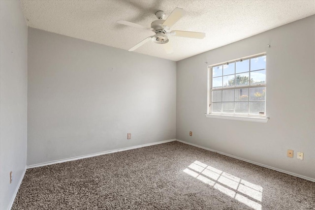 carpeted empty room with ceiling fan and a textured ceiling