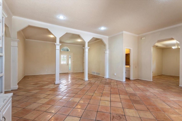 interior space with light tile patterned flooring, ornamental molding, decorative columns, and a textured ceiling