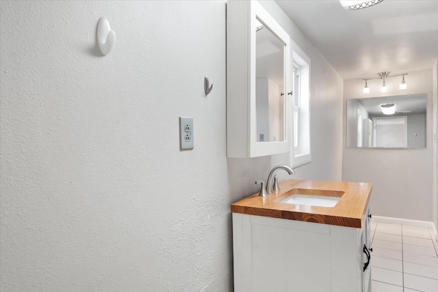 bathroom with tile patterned flooring and vanity