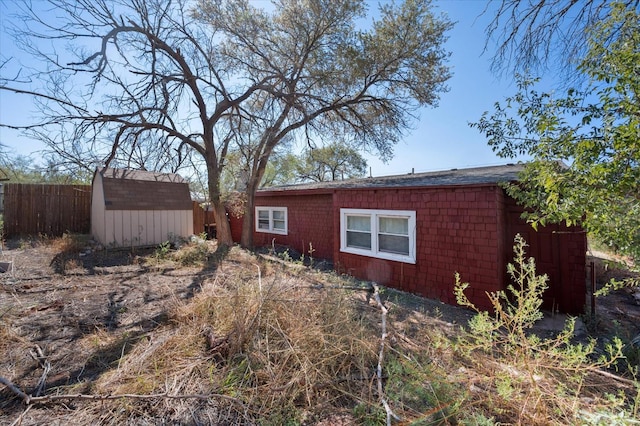 view of side of property with a shed