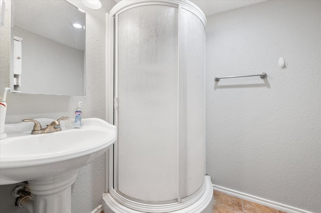 bathroom with sink and walk in shower