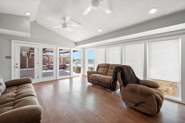 living room with wood-type flooring, high vaulted ceiling, and ceiling fan