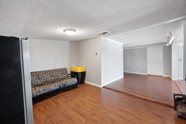 sitting room featuring hardwood / wood-style floors and a textured ceiling