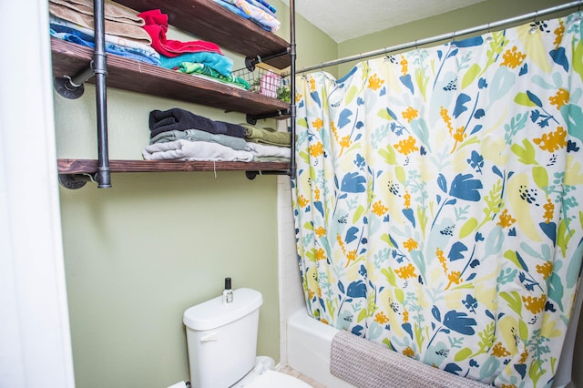 bathroom with shower / tub combo and toilet
