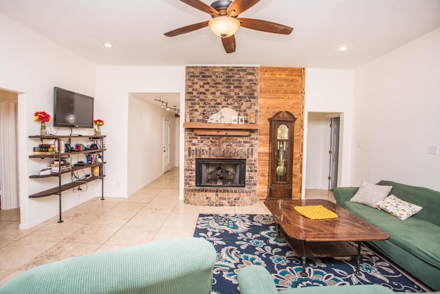 living area featuring ceiling fan, a fireplace, tile patterned flooring, recessed lighting, and baseboards