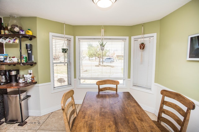 dining area featuring plenty of natural light, baseboards, and tile patterned flooring