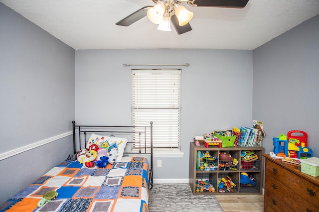 bedroom featuring baseboards and a ceiling fan