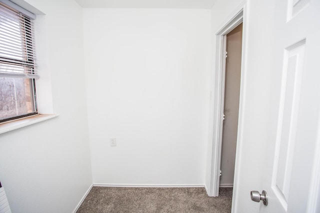 interior space with baseboards and carpet