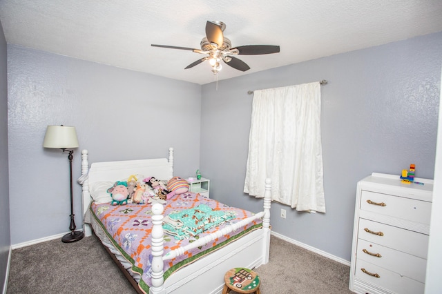 carpeted bedroom with ceiling fan and baseboards