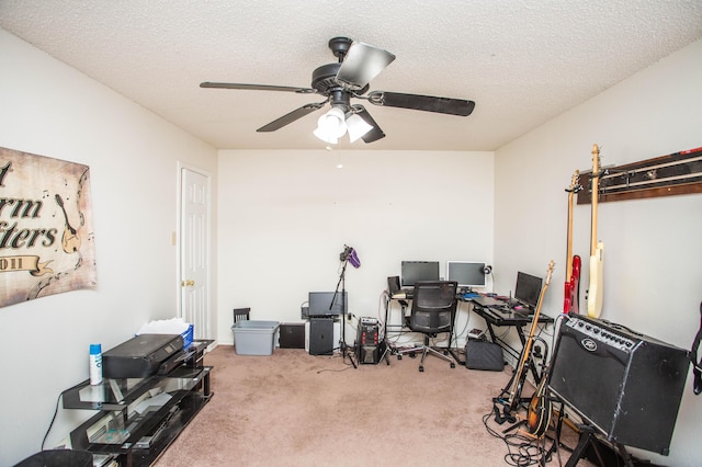 office space featuring a textured ceiling, a ceiling fan, and carpet floors
