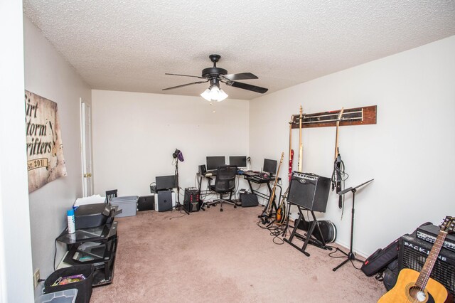 recreation room featuring a textured ceiling, a ceiling fan, and carpet