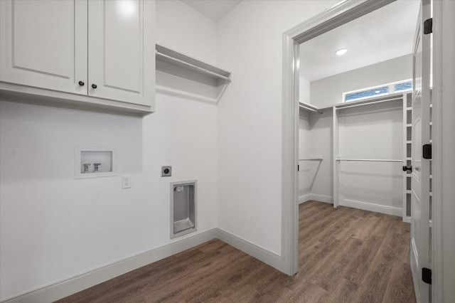 washroom featuring dark hardwood / wood-style flooring, hookup for a washing machine, cabinets, and hookup for an electric dryer