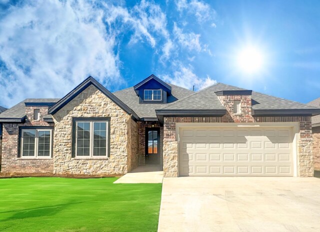 view of front of property with a garage and a front yard