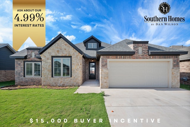 view of front of home featuring a garage, brick siding, driveway, and a front yard