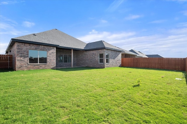 rear view of house with a yard