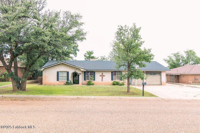 303 Comanche Trl, Tulia, TX 79088 - ranch-style home with driveway, brick siding, a front lawn, and a garage