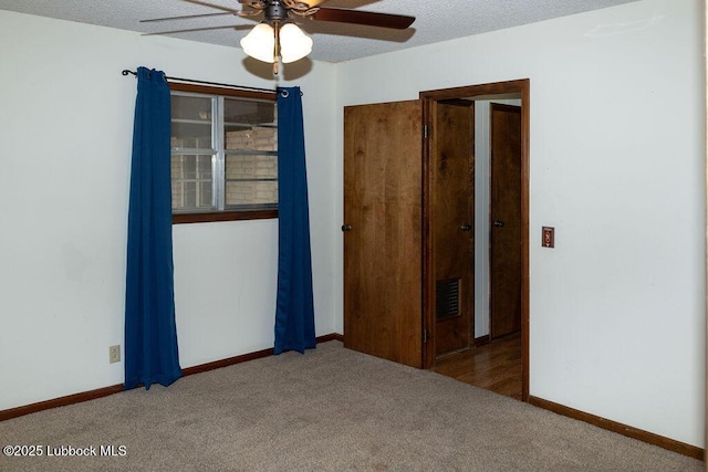 303 Comanche Trl, Tulia, TX 79088 - spare room featuring a ceiling fan, carpet floors, and a textured ceiling