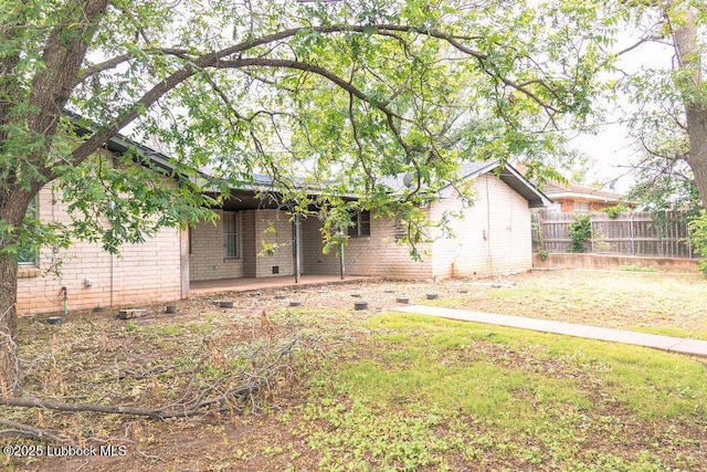 303 Comanche Trl, Tulia, TX 79088 - back of property with brick siding and a patio