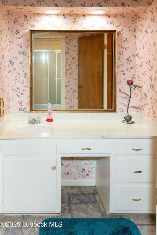 303 Comanche Trl, Tulia, TX 79088 - bathroom featuring wallpapered walls, vanity, and a stall shower