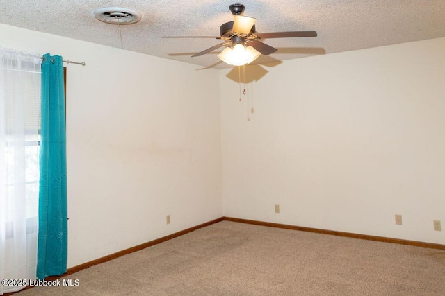 303 Comanche Trl, Tulia, TX 79088 - spare room featuring ceiling fan, light colored carpet, and a textured ceiling