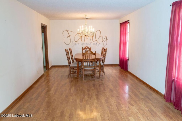 303 Comanche Trl, Tulia, TX 79088 - dining space with wood finished floors and a chandelier