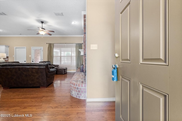 1507 Nottingham Ave, Wolfforth, TX 79382 - foyer with ornamental molding, a ceiling fan, wood finished floors, and baseboards