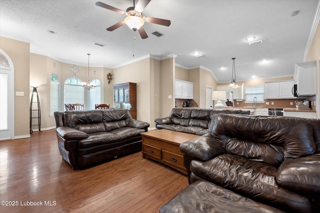 1507 Nottingham Ave, Wolfforth, TX 79382 - living room with a ceiling fan, a chandelier, wood finished floors, recessed lighting, and a textured ceiling