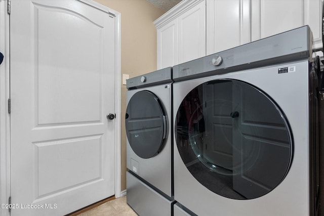 1507 Nottingham Ave, Wolfforth, TX 79382 - washroom featuring independent washer and dryer, cabinet space, and light tile patterned flooring