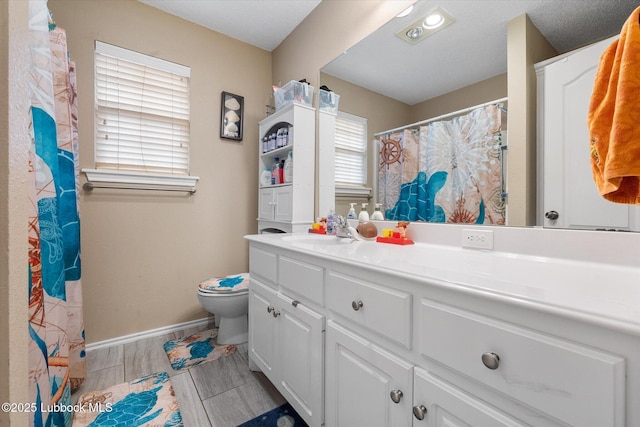 1507 Nottingham Ave, Wolfforth, TX 79382 - bathroom featuring double vanity, toilet, baseboards, and a shower with curtain