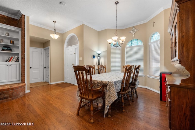 1507 Nottingham Ave, Wolfforth, TX 79382 - dining room featuring wood finished floors, baseboards, a chandelier, and ornamental molding