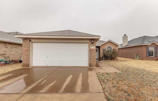 ranch-style home featuring a garage, concrete driveway, and brick siding