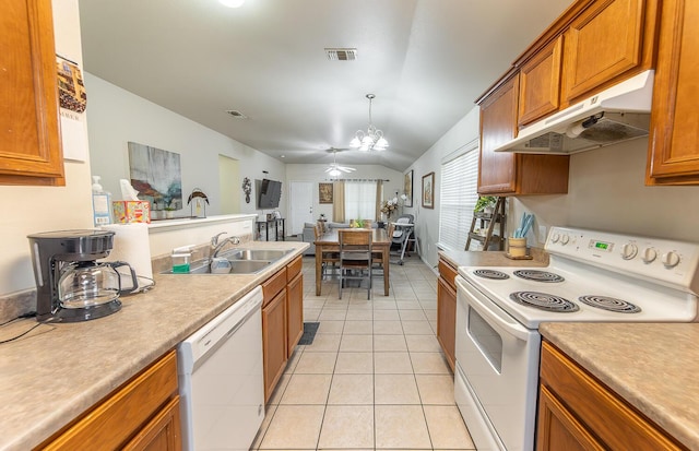 kitchen with light tile patterned floors, visible vents, a sink, white appliances, and under cabinet range hood