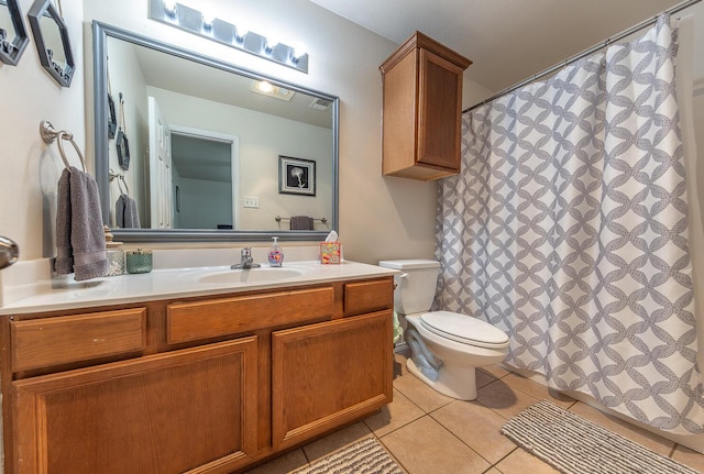 bathroom with tile patterned flooring, curtained shower, vanity, and toilet