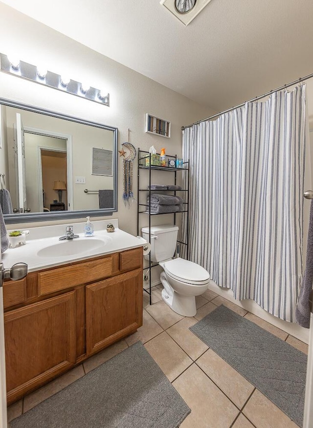 full bathroom with a shower with curtain, lofted ceiling, toilet, vanity, and tile patterned flooring