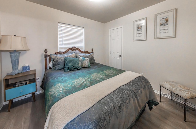 bedroom featuring baseboards and wood finished floors