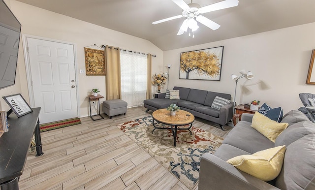 living room featuring vaulted ceiling, a ceiling fan, and wood finish floors