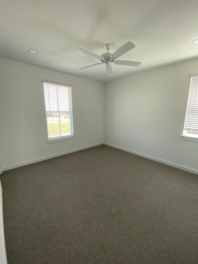 carpeted empty room featuring ceiling fan