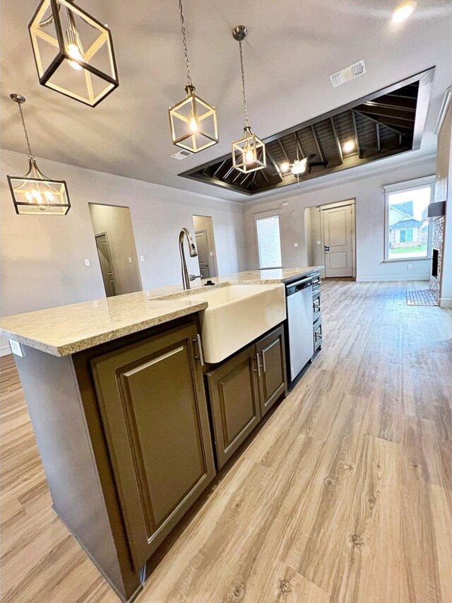 kitchen with dark brown cabinetry, decorative light fixtures, dishwasher, and a kitchen island with sink