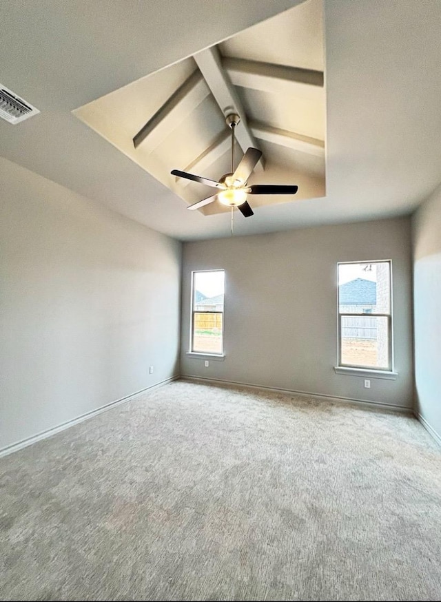 carpeted empty room featuring vaulted ceiling with beams and ceiling fan