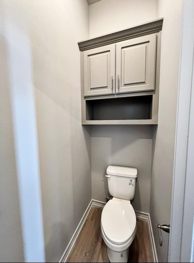 bathroom featuring hardwood / wood-style floors and toilet