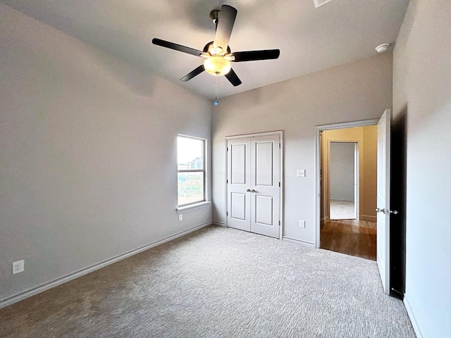 unfurnished bedroom with a closet, ceiling fan, and carpet flooring