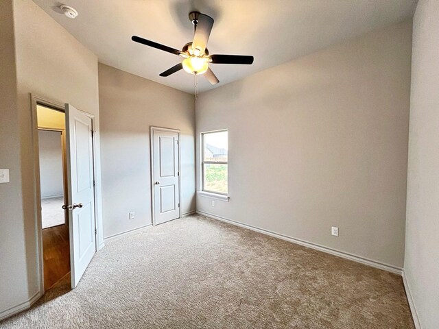 unfurnished bedroom with ceiling fan and carpet