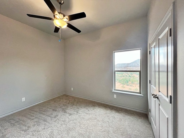 carpeted empty room with ceiling fan