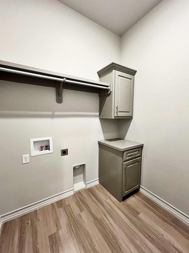 washroom with washer hookup, cabinets, wood-type flooring, and hookup for an electric dryer