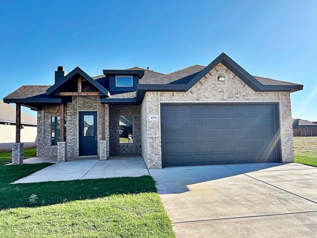 view of front of property with a garage and a front yard