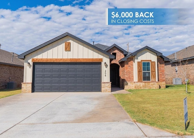 view of front of home featuring central AC unit, a garage, and a front lawn