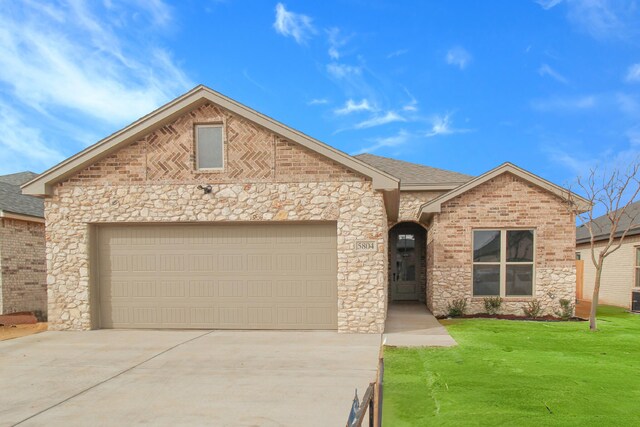 view of front of home featuring a front yard, a shingled roof, concrete driveway, a garage, and brick siding