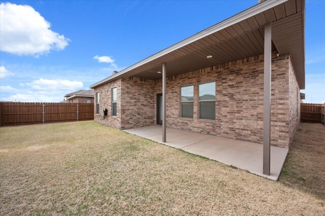 back of house featuring a yard and a patio area