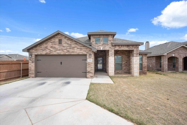 view of front of home featuring a garage and a front yard