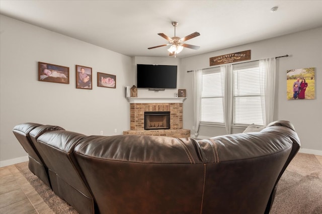 living room featuring a fireplace and ceiling fan